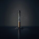 A single burnt-down cigarette standing upright in a small pile of ash against a dark background